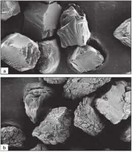 Figure 3.13 Comparison of monocrystalline a) and polycrystalline b) synthetic diamond grain shapes (SEM, 450X).