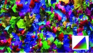 Figure 3.18 Vibratory polished ferritic steel, Electron image overlayed with orientation map normal direction Phase α - Iron.